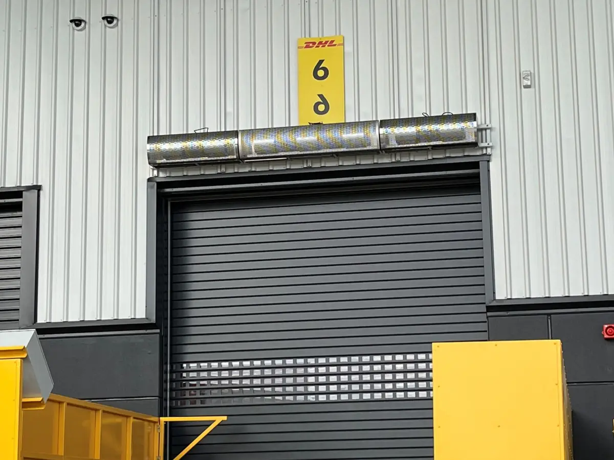 Remote activating Industrial air curtain above a customised roller shutter on the exterior door of a industrial warehouse facility