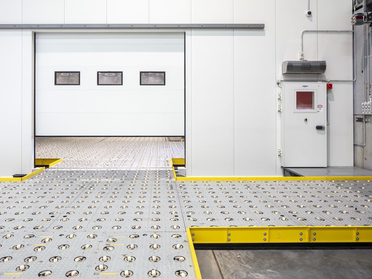 A partially open sectional door inside a warehouse of DHL Brisbane Airport