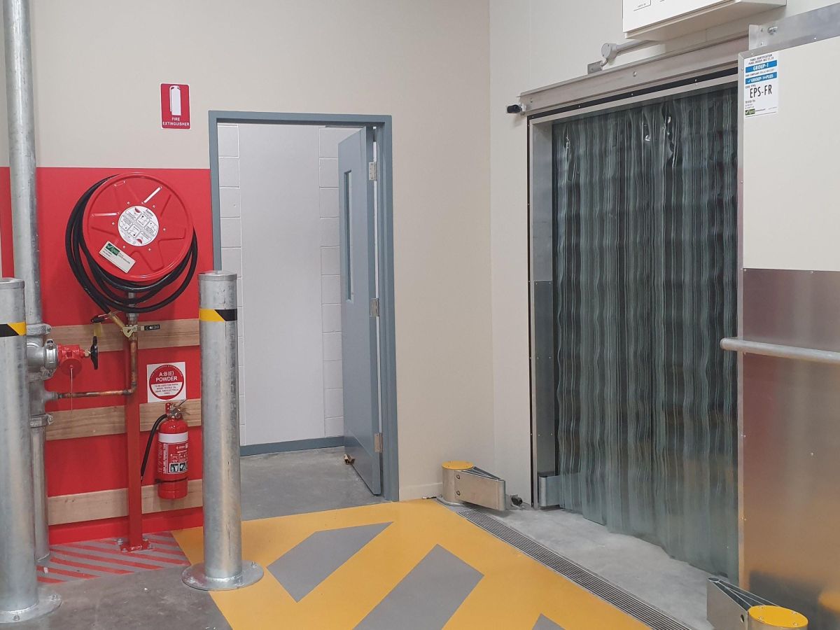 Clear plastic PVC Strip curtains hung in the cool room doorway of a supermarket.