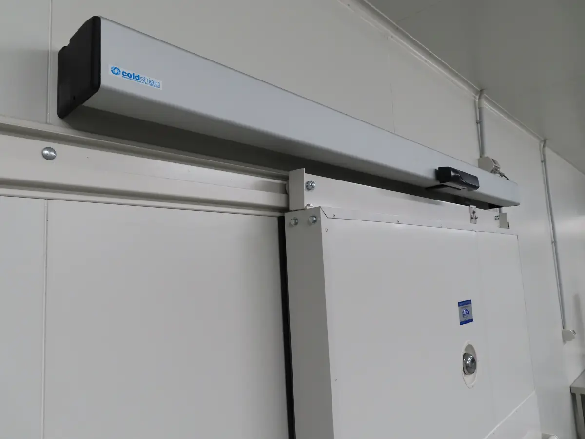 An automatic operator on an automatic sliding door inside a factory of Tasty Fresh