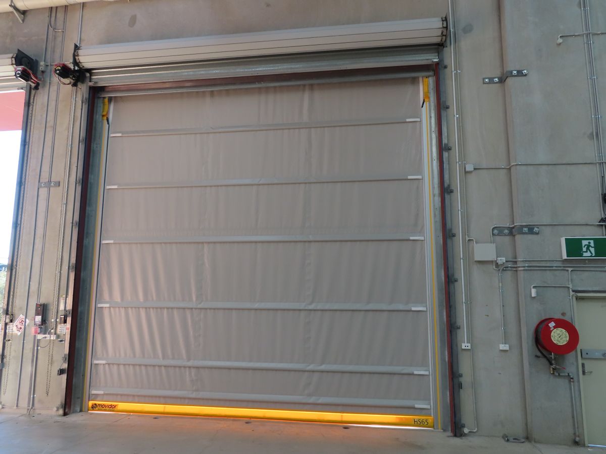 A large high speed door on the inside of a food processing factory.