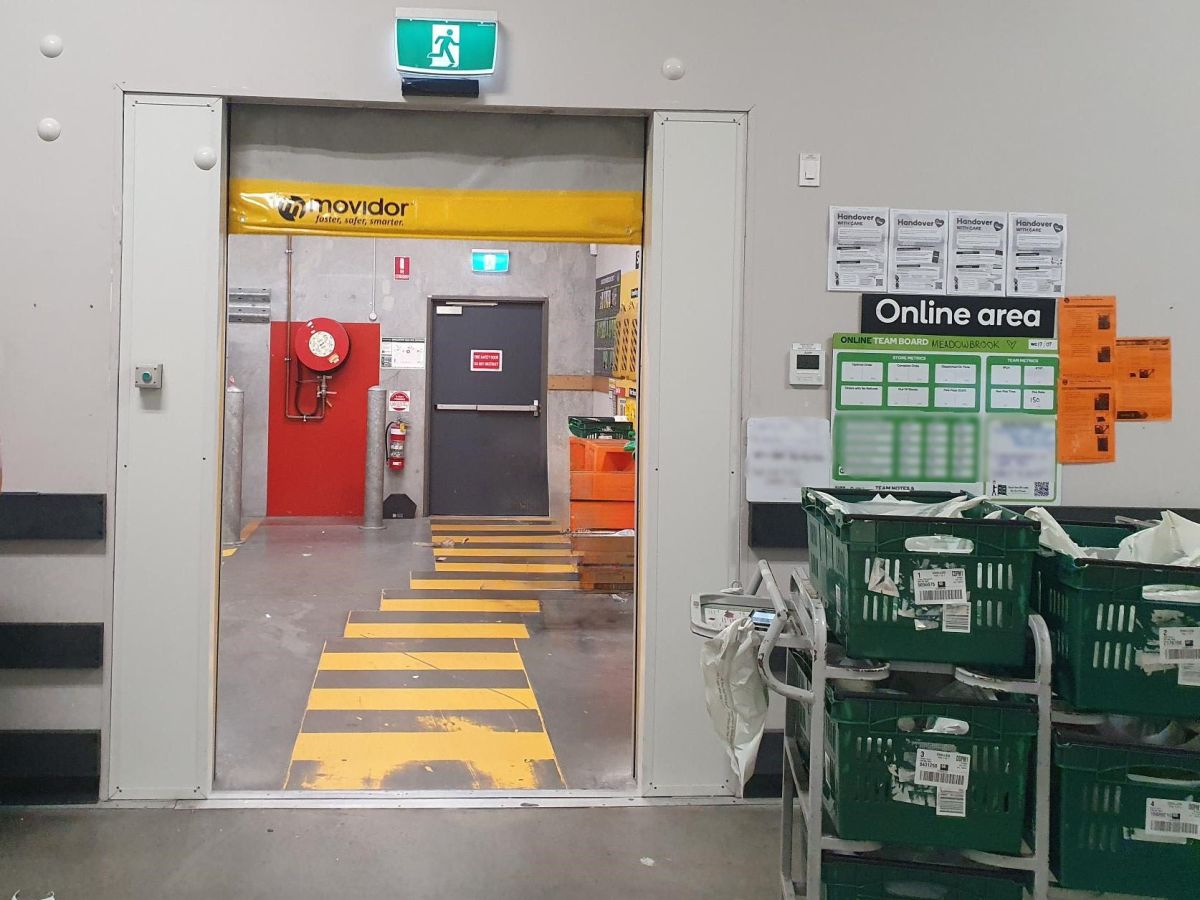 An open rapid door in a staff area of a supermarket.