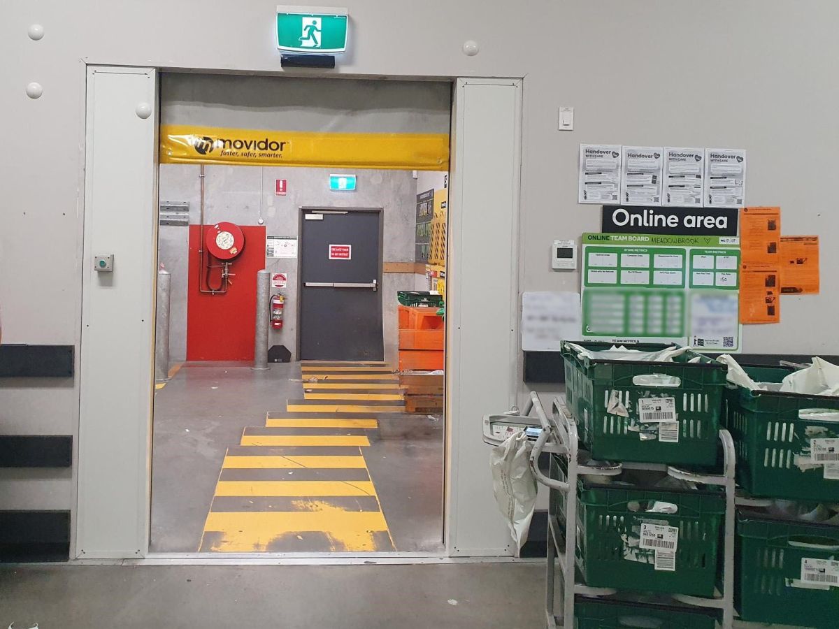 An opening grey Movidor HS35 high speed rapid door viewd from the staff area of WW Meadowbrook
