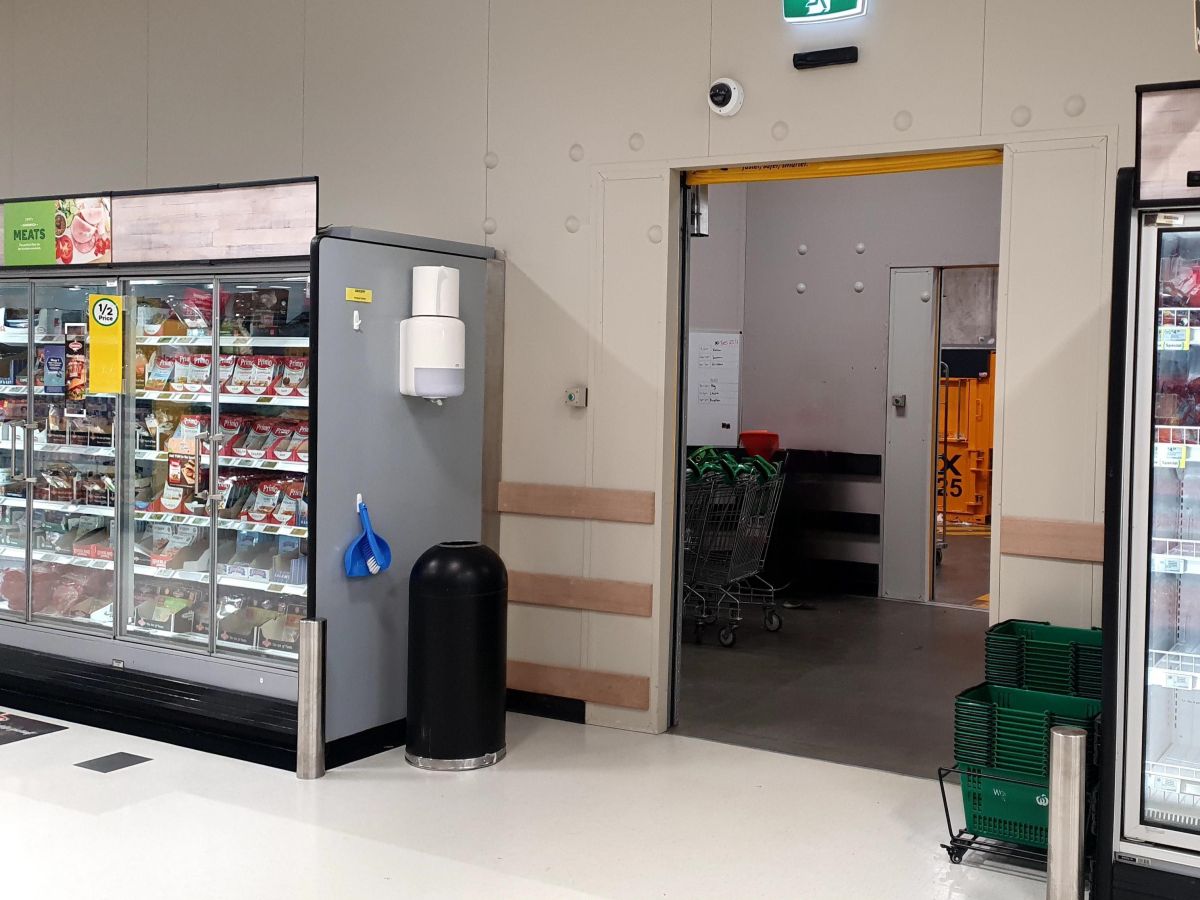 An open rapid door inside a supermarket.