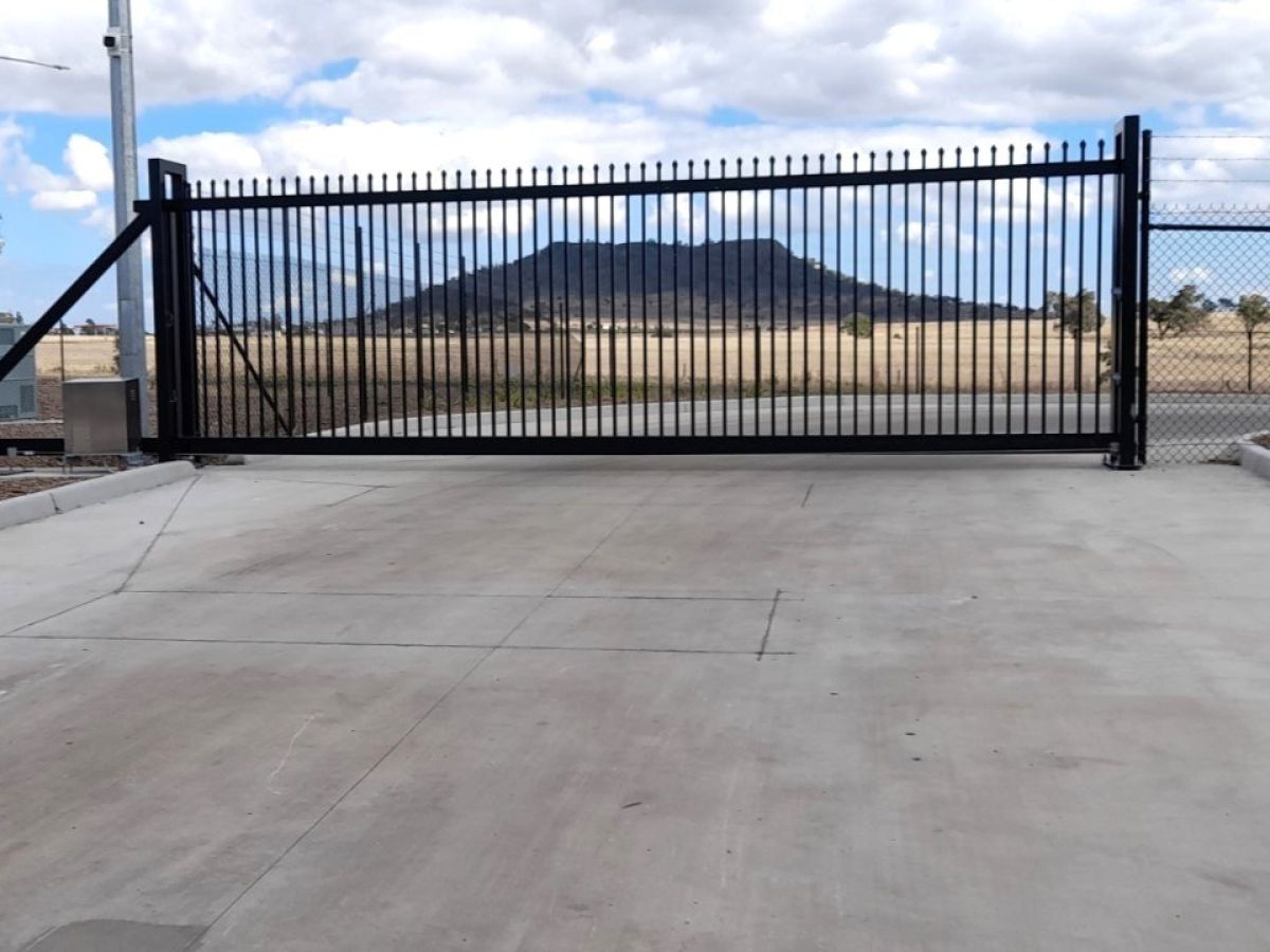 A closed automatic gate at an industrial park.