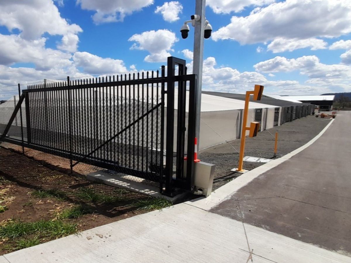 An open automatic gate at an industrial park.