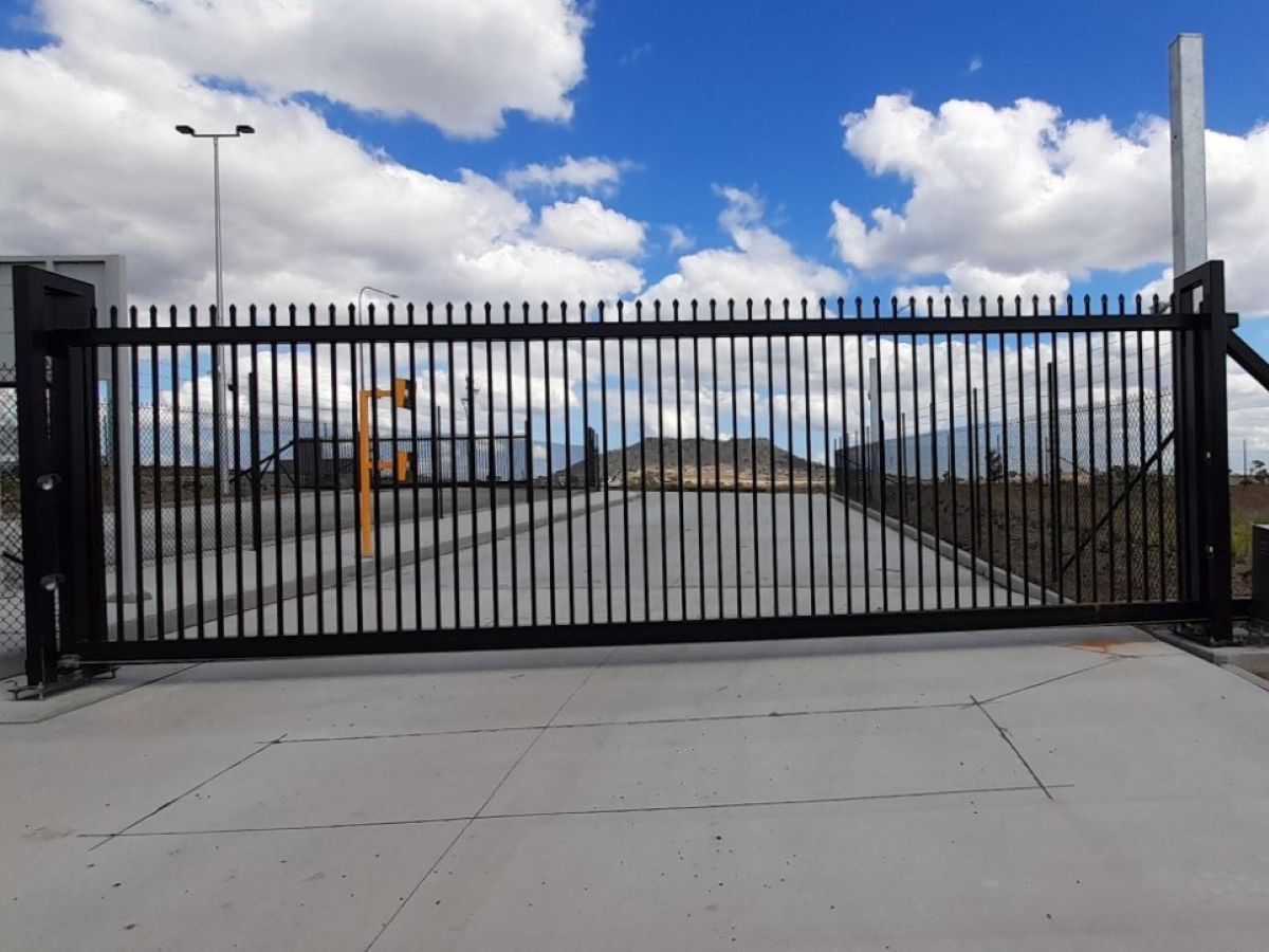 A closed automatic gate at an industrial park.