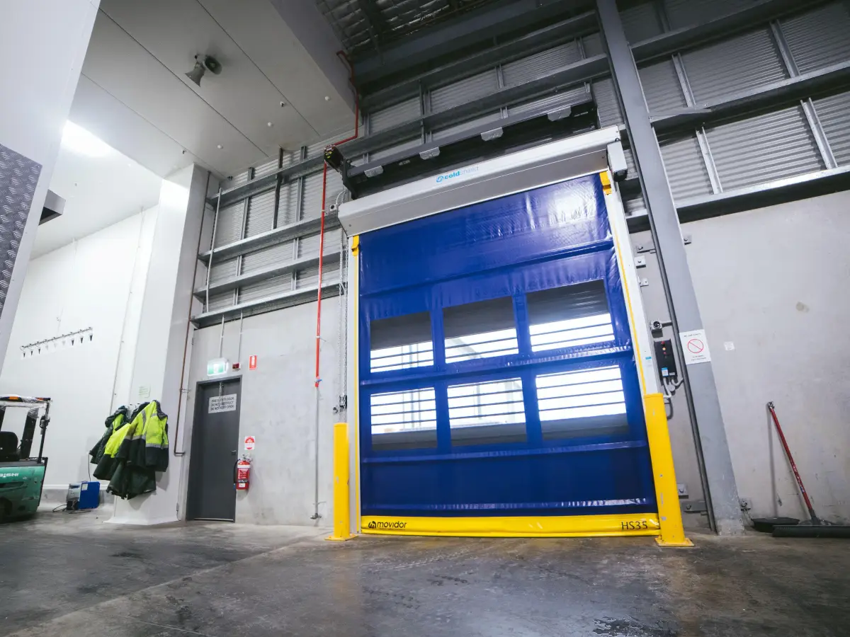A closed rapid roll door inside a warehouse.