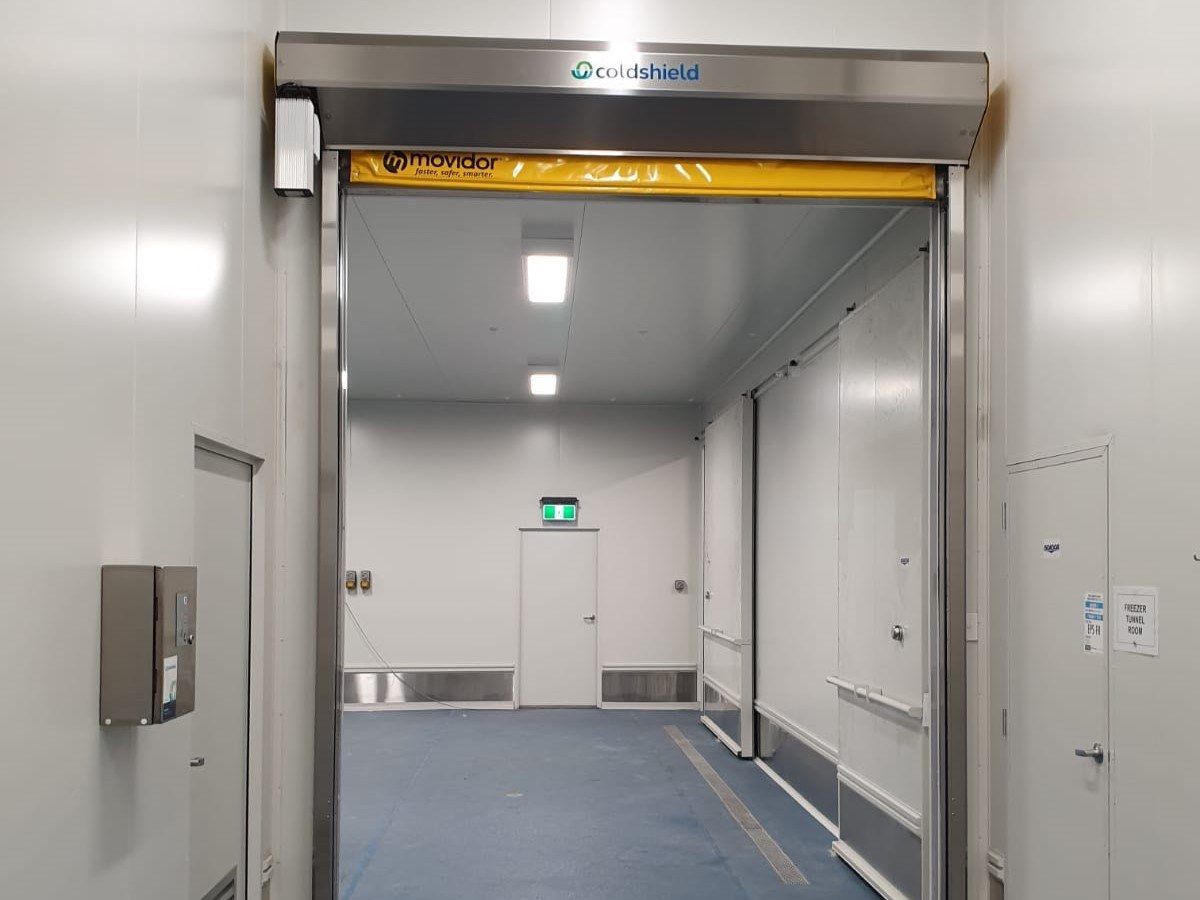 An open rapid door inside a factory.