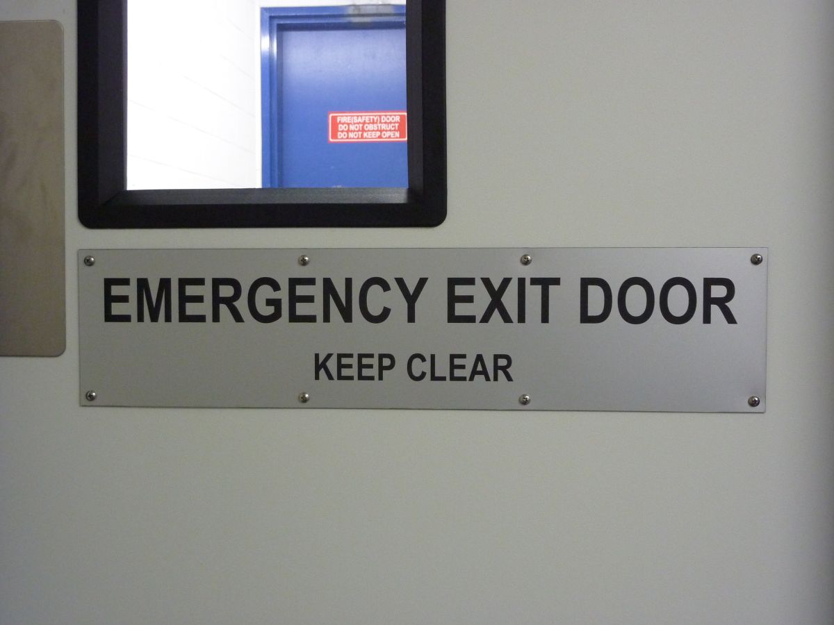 An emergency exit sign on a door.