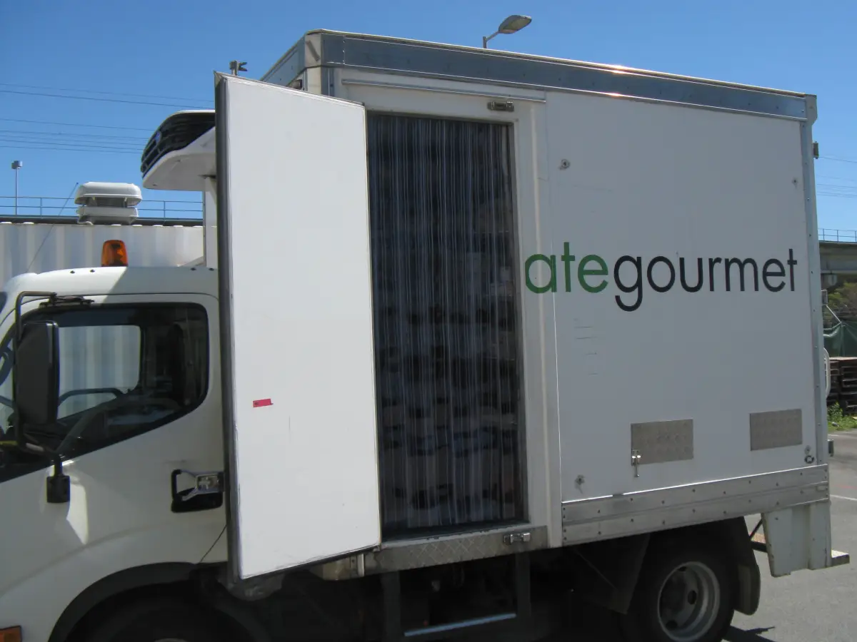 Customised clear pvc strip curtain on the side access door of a food production refrigerated truck.