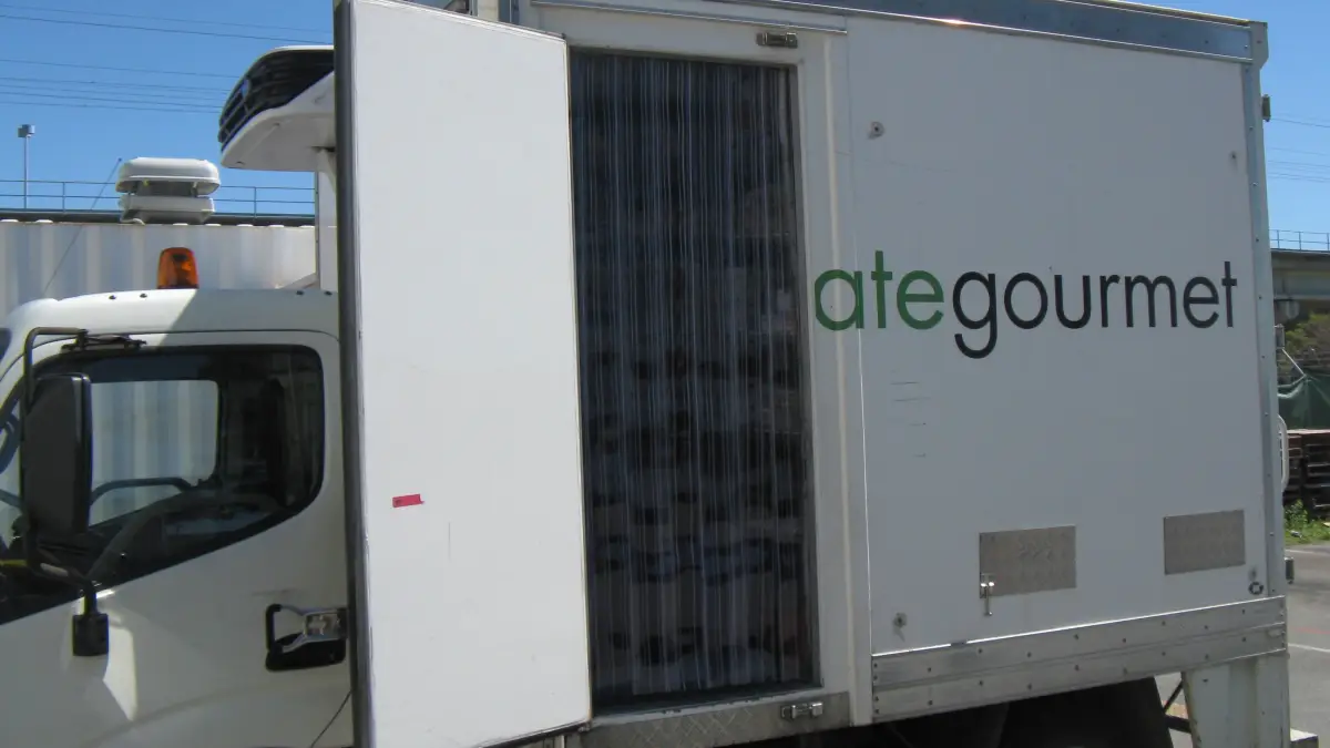 Customised clear pvc strip curtain on the side access door of a food production refrigerated truck.