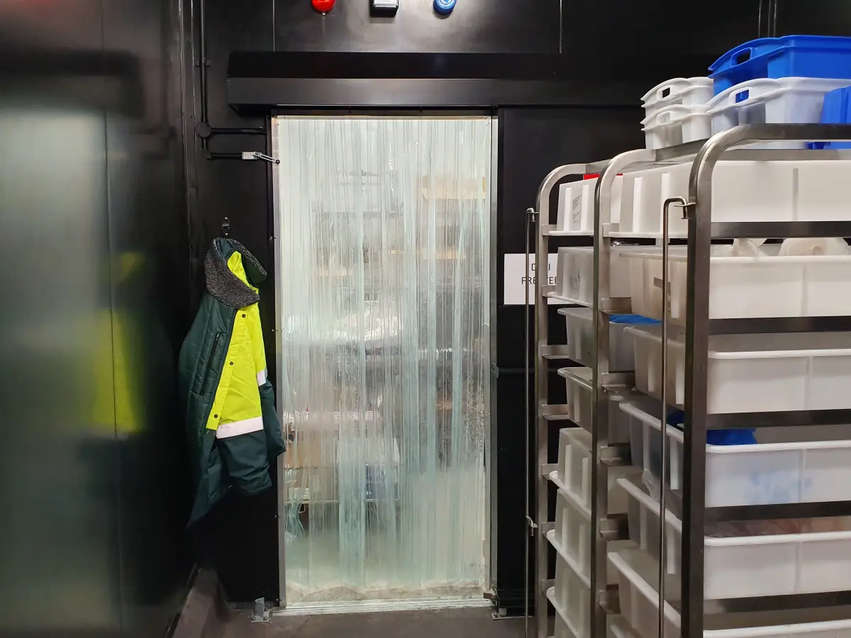Clear plastic PVC Strips with door curtain mounting system in a freezer room of Coles Rochedale