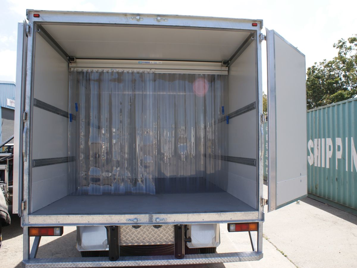 A Compass movable strip curtain system inside a refrigerated truck.