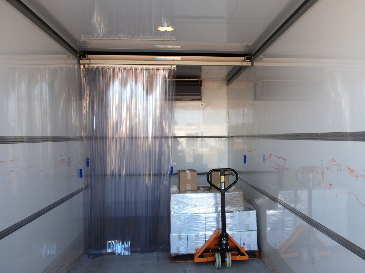 A Compass PVC sliding system inside a refrigerated truck.