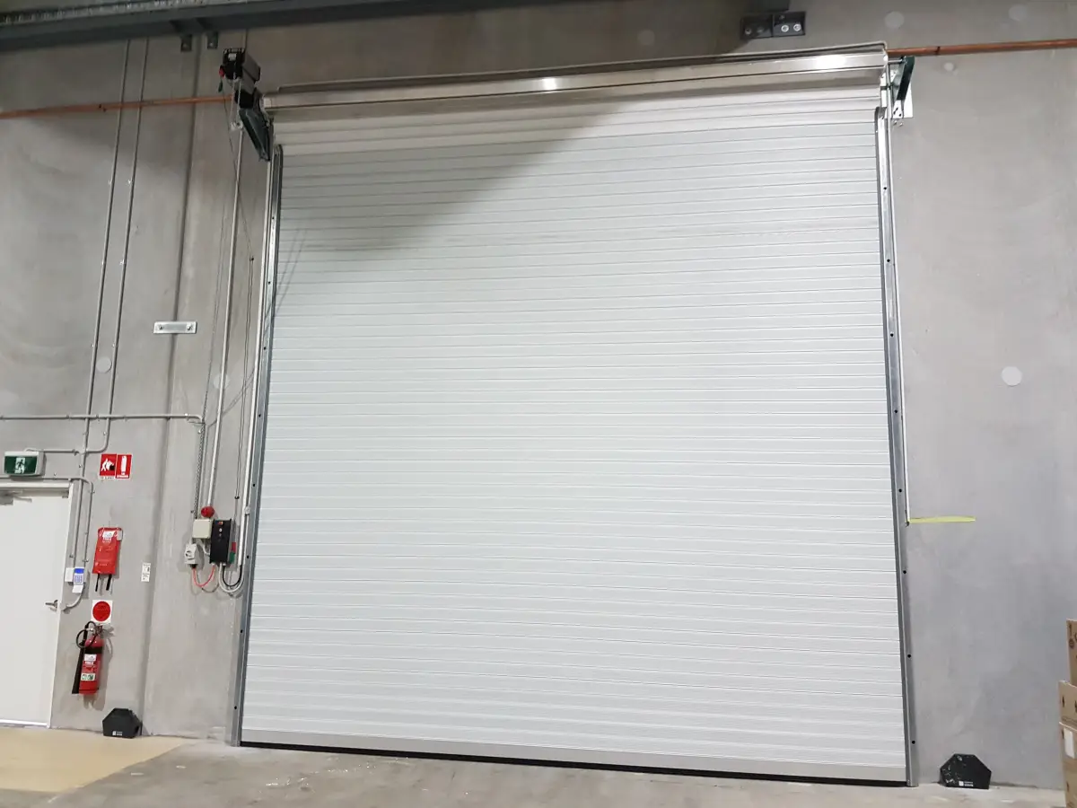 A closed white high speed roller shutter.