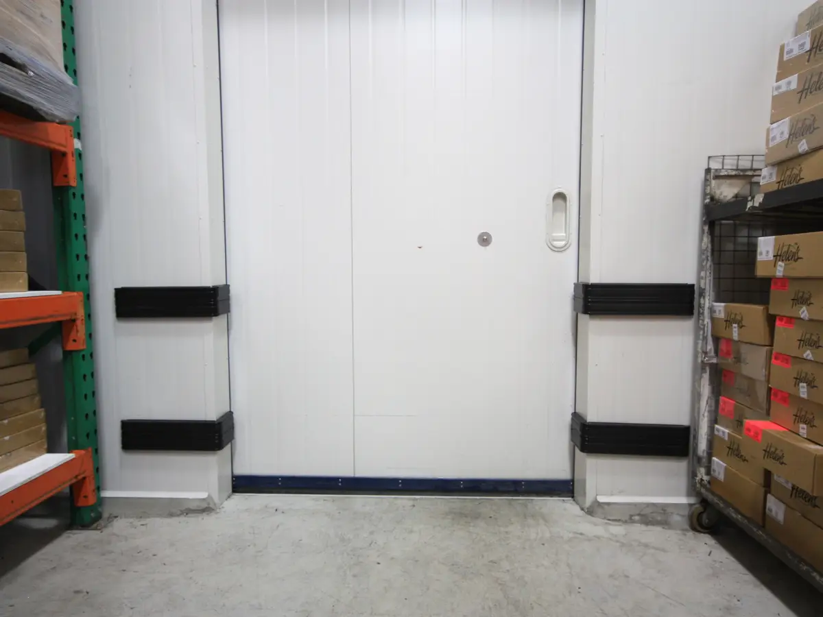 bump rail wall protection system, manufactured from premium A3 grade extruded PVC. Bump rails shown next to a door inside a warehouse.