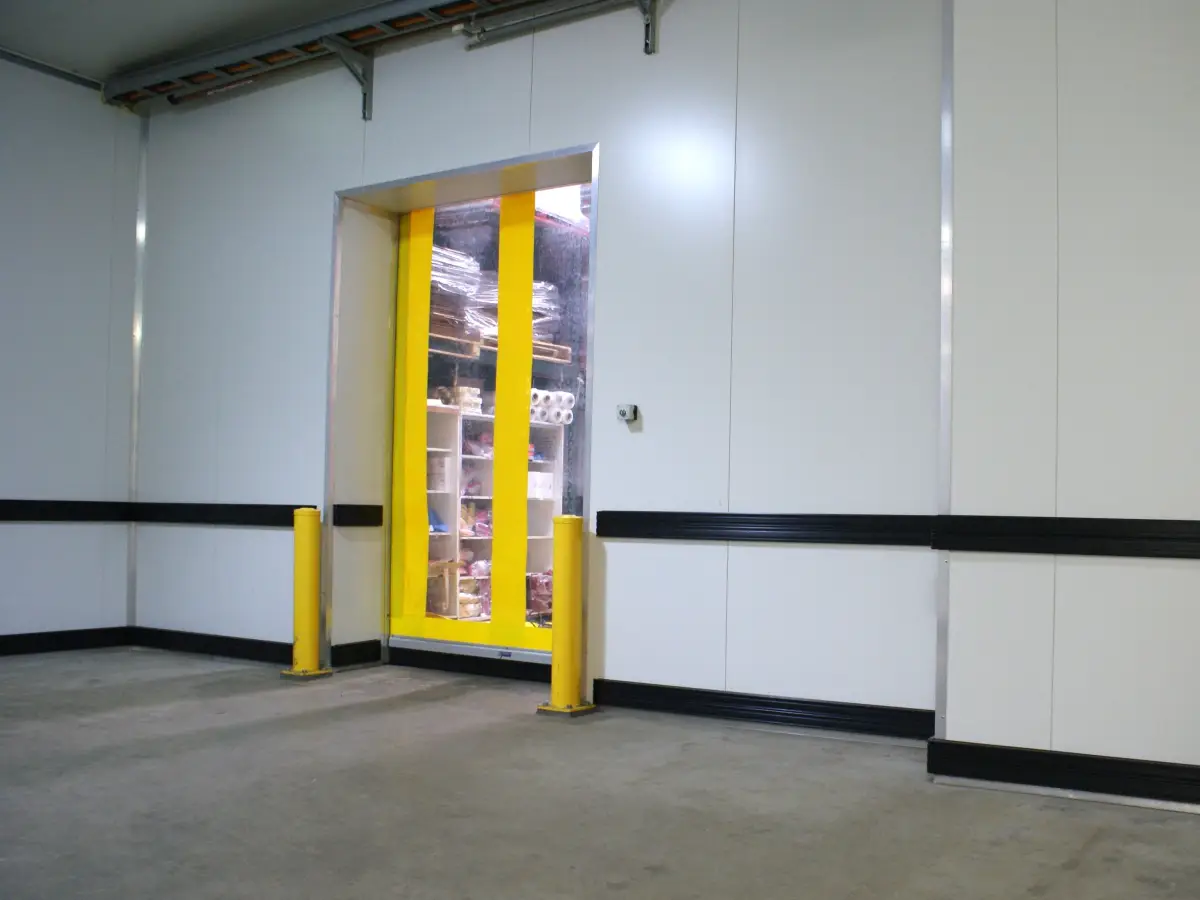 Bump rail wall protection system, heavy duty bollards and a rapid roll high speed door inside a food processing factory
