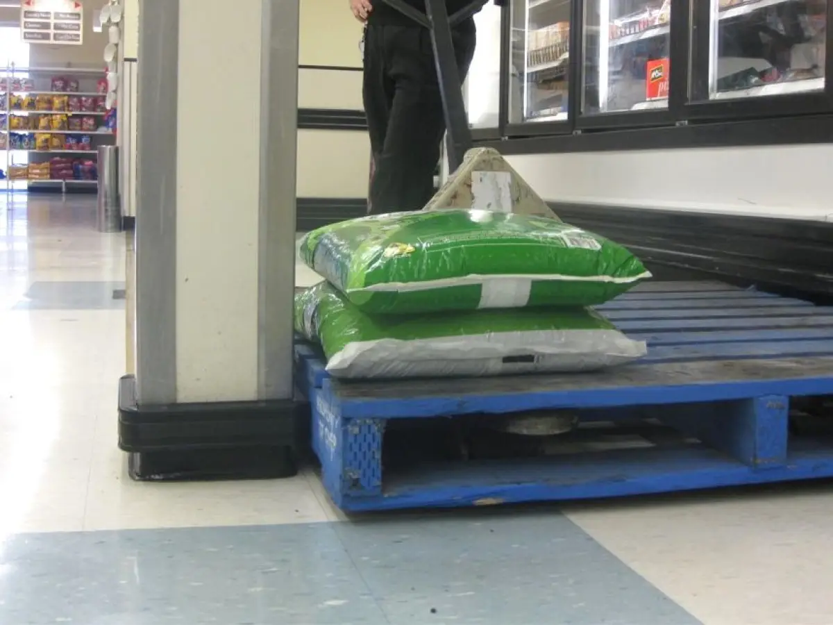 Bumprails shown protecting a pole in a supermarket; plasticised vinyl wall protection against heavy impact.