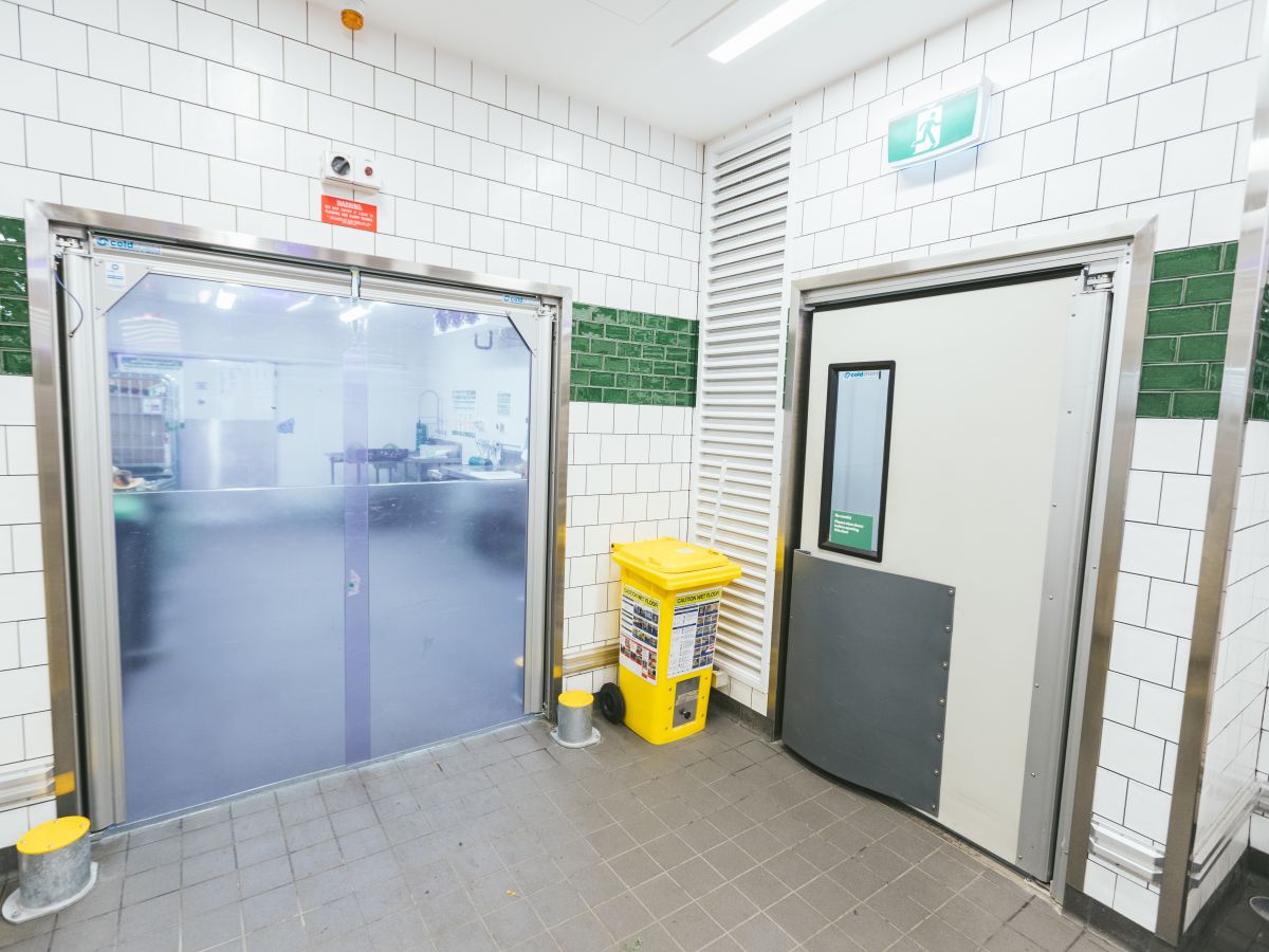Traffic door and PVC swing door in the staff area of a supermarket.