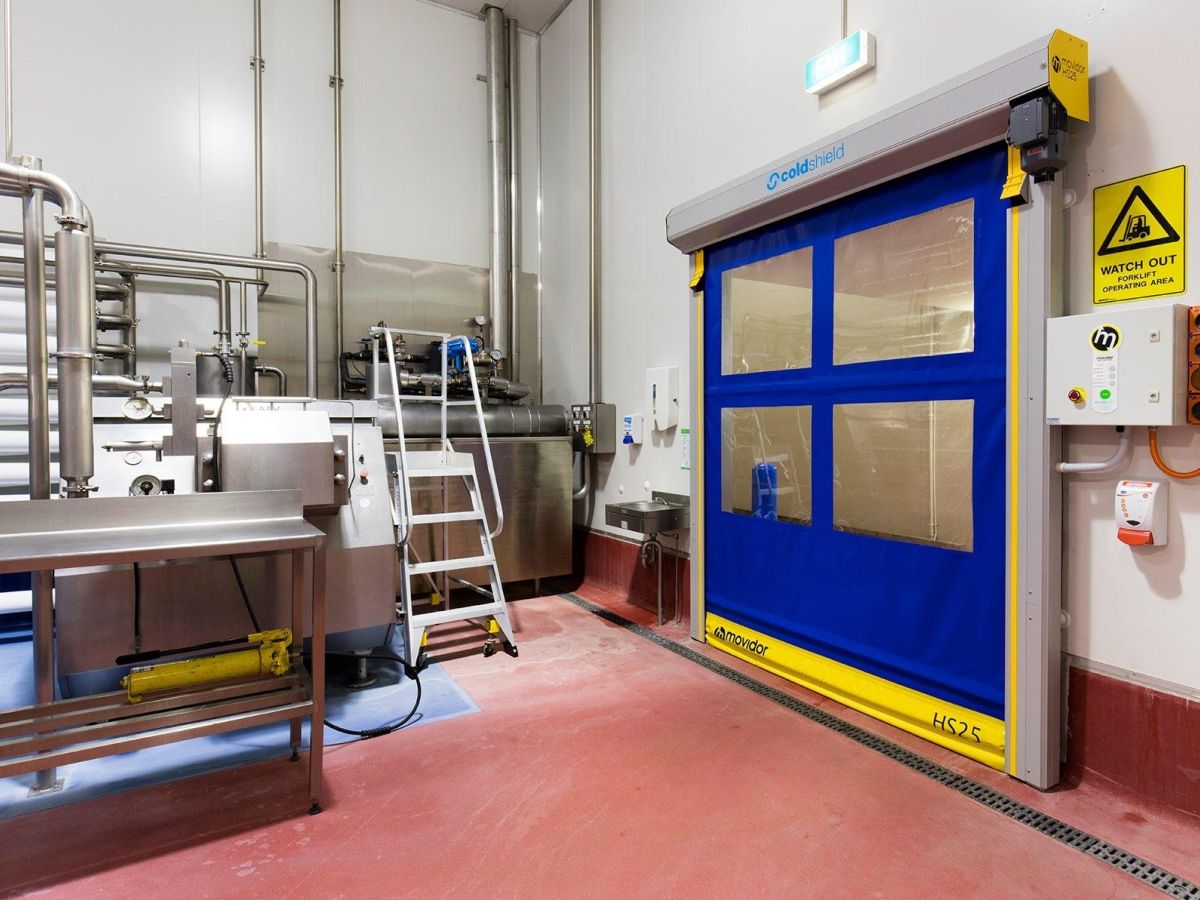 A closed blue rapid roll door inside a factory.