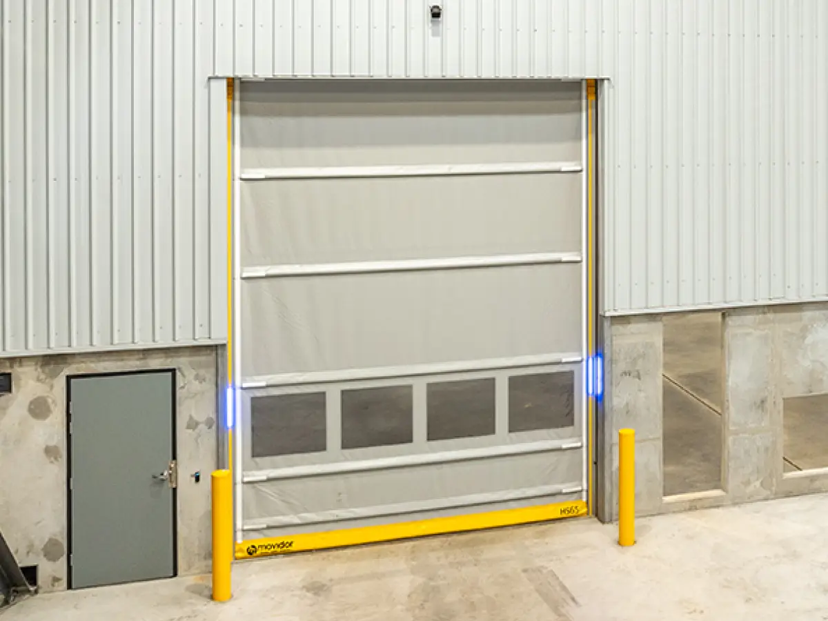 Interior of a pharmaceutical warehouse with a closed Movidor HS series high speed rapid roller door with mesh windows