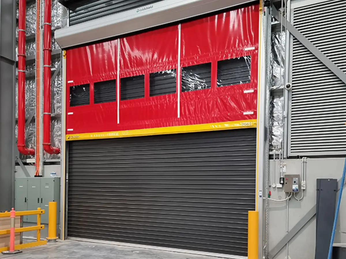 DHL Brisbane industrial warehouse with a Coldshield Movidor HS series high speed rapid door in front of a custom insulated sectional door