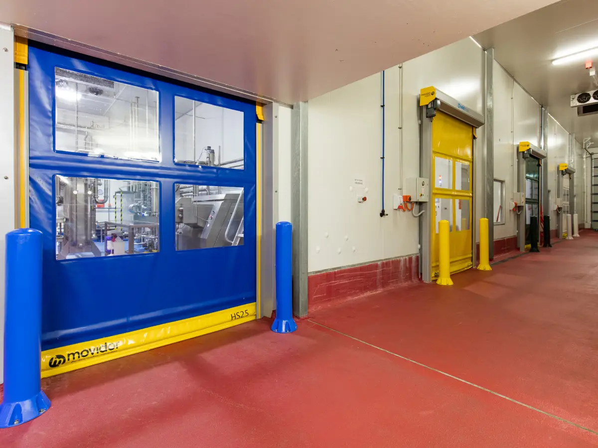 HS25 pvc roller door blue curtain and polyethylene bollards in a food processing plant