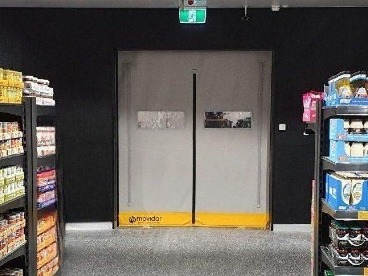 A grey high speed rapid door inside a supermarket.