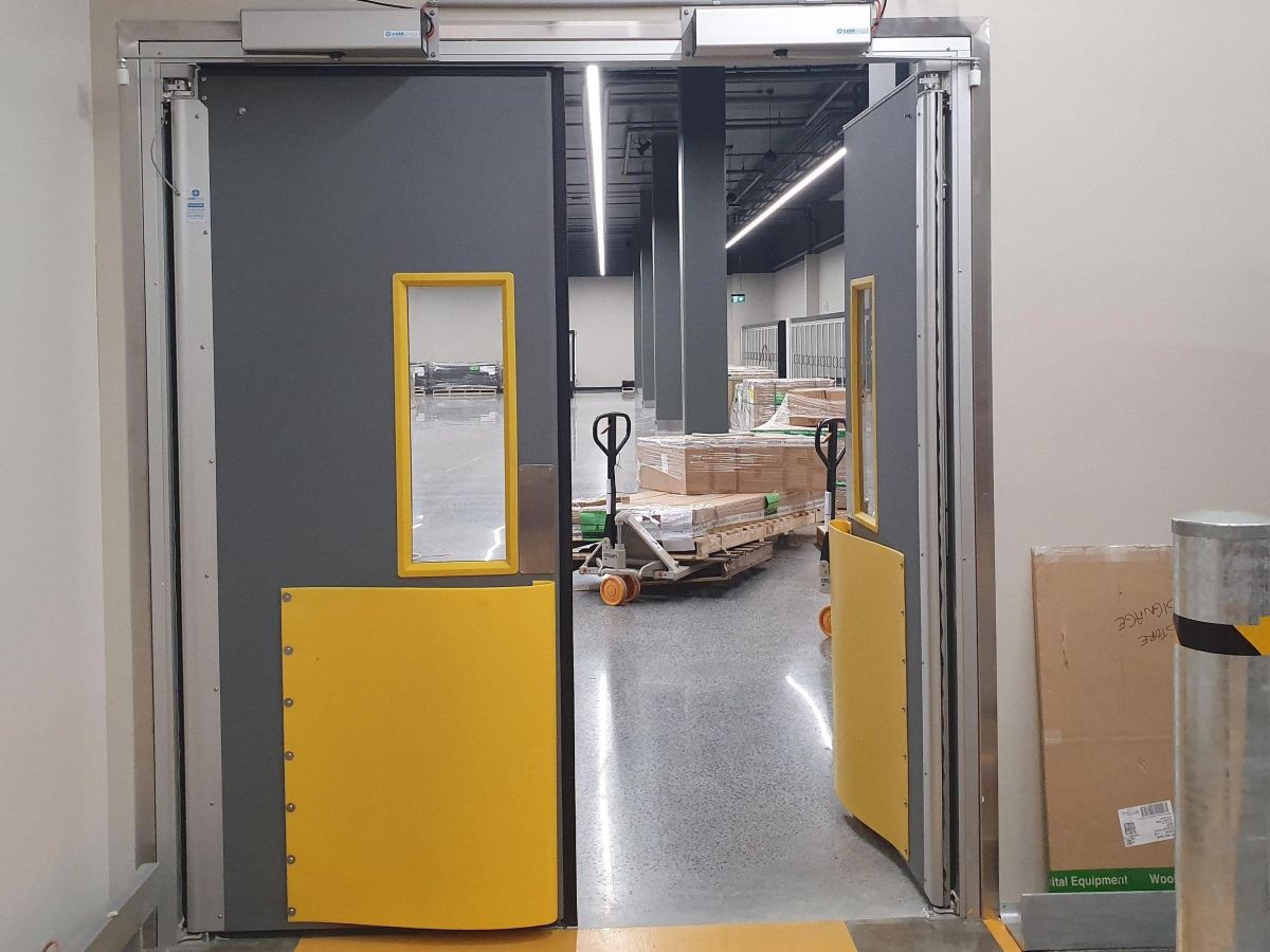 An open Coldshield 4500 Series thermal swing traffic door leading through to supermarket backroom iof WW West End