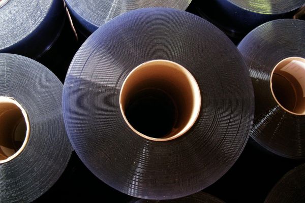 Rolls of PVC strips in a warehouse.