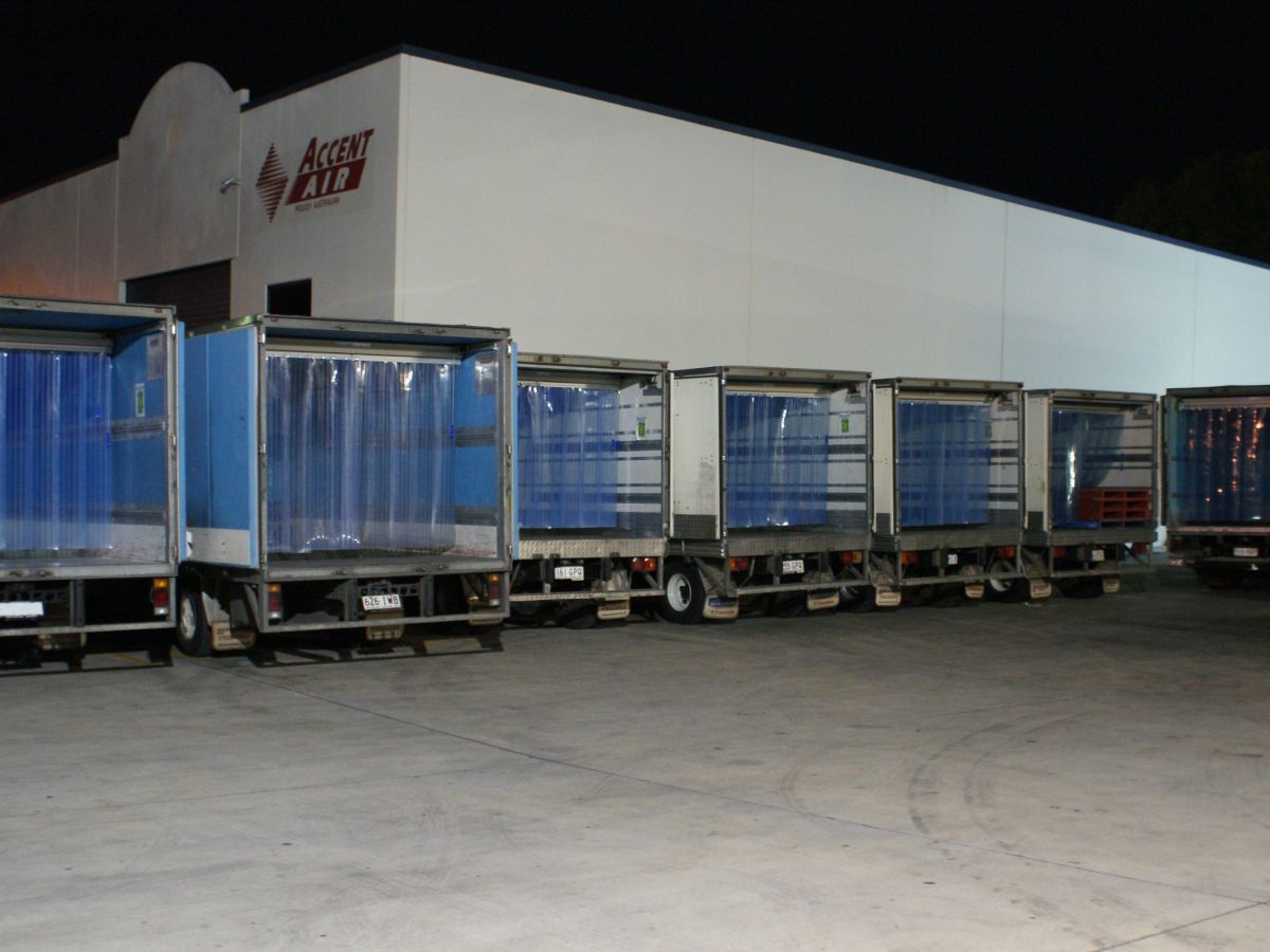 A line of refrigerated trucks with the Compass system of movable PVC strips installed inside.