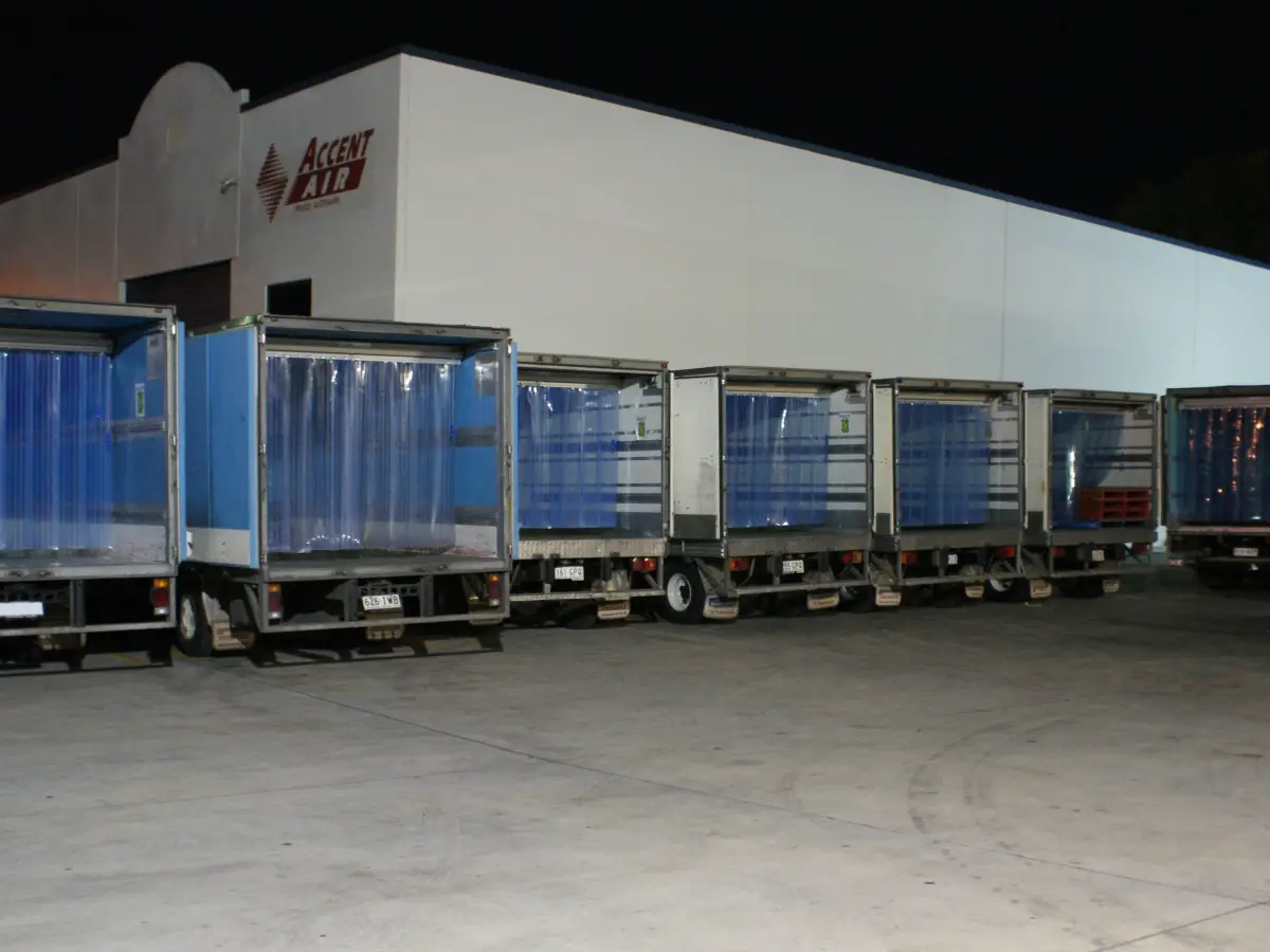 A line of Foodlink refrigerated trucks with the Compass system of movable PVC strip curtains
