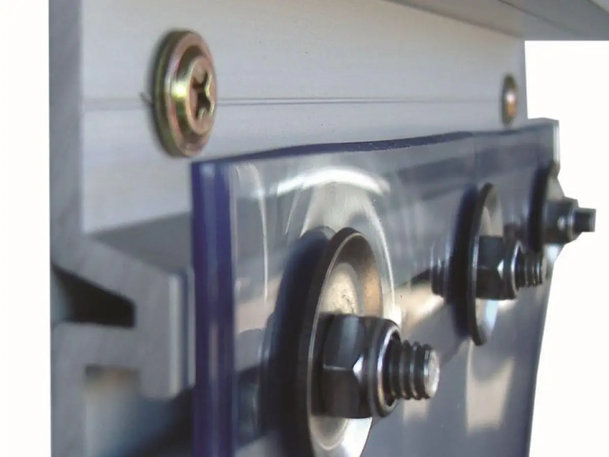 A PVC strip curtain mounting system; clear plastic strips with a heavy mount attachment on an industrial door.