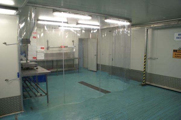 A PVC screen separating a work area in a food processing factory.