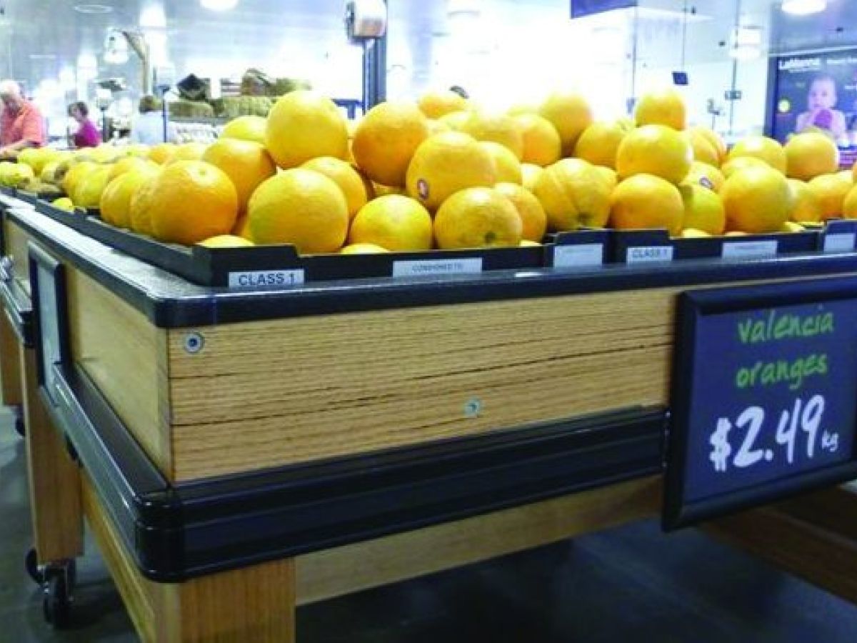 Black PVC bumprails around a produce display in a supermarket.