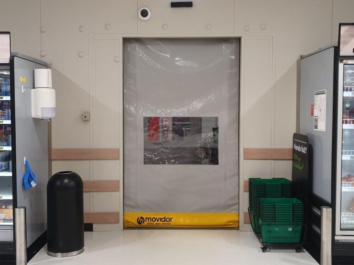 A grey custom tailored Movidor HS35 high speed rapid door with window inside WW Meadowbrook