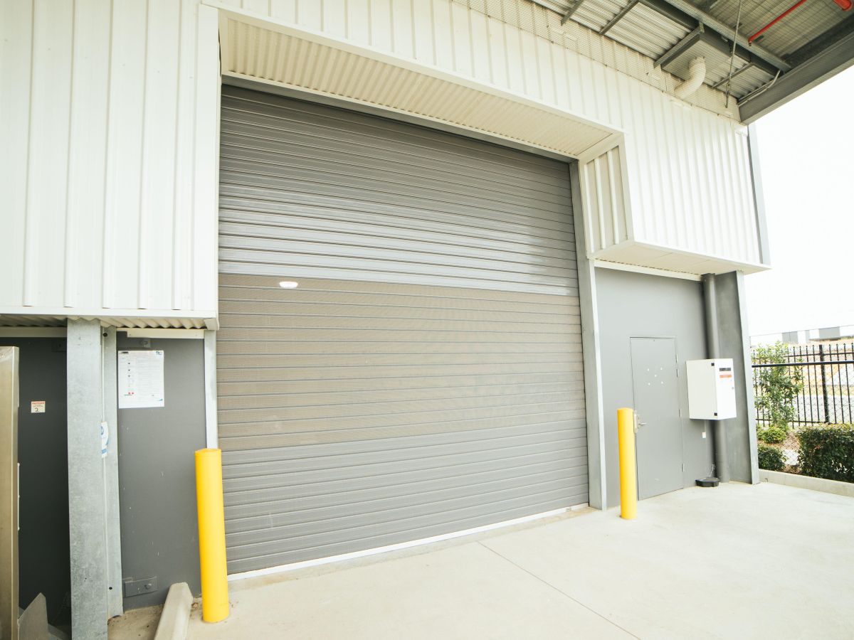 A closed roller shutter on an industrial building.