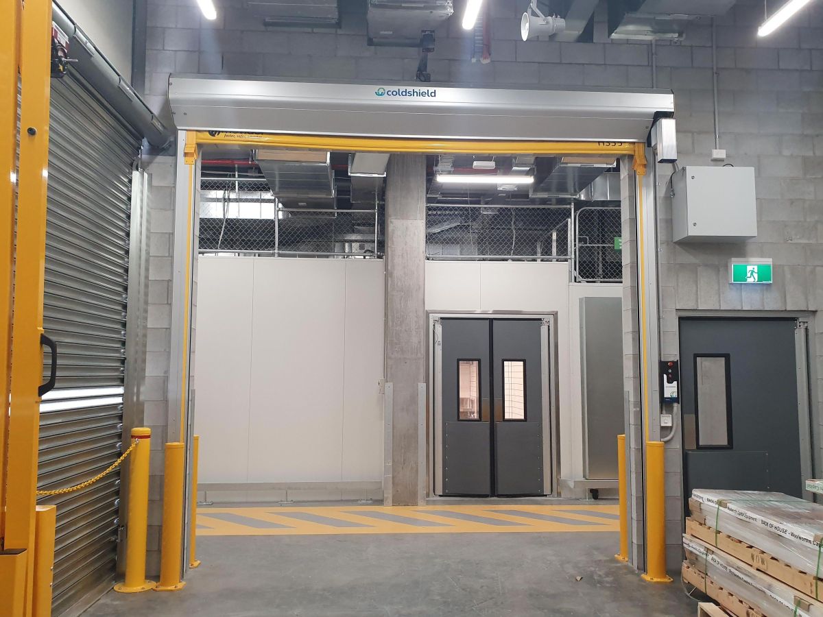 An open EX SERIES high speed rapid door with UPS backup battery power in the loading dock area of WW Montague West End