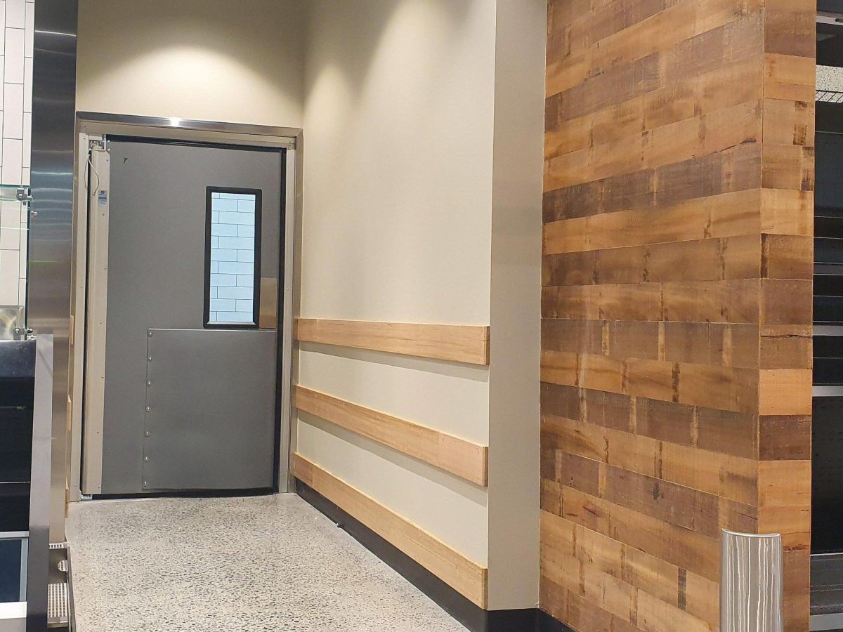 A Coldshield 4500 Series traffic swing door inside WW Montague West End