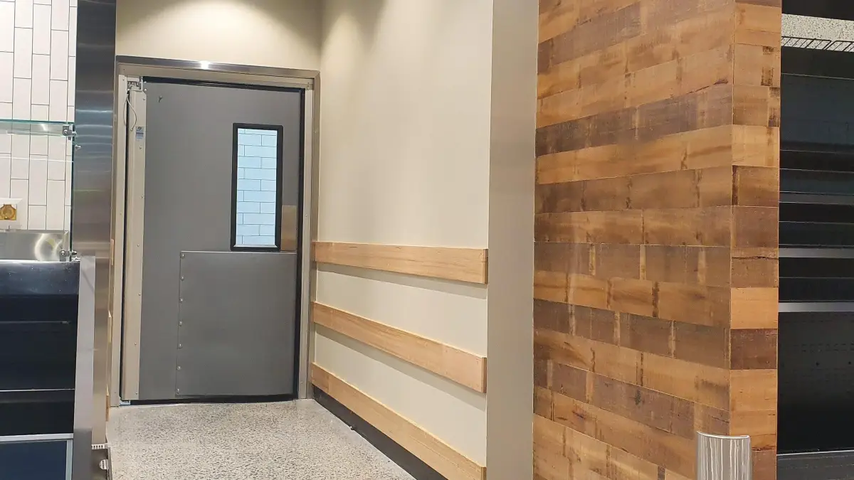 A Coldshield 4500 Series traffic swing door inside WW Montague West End