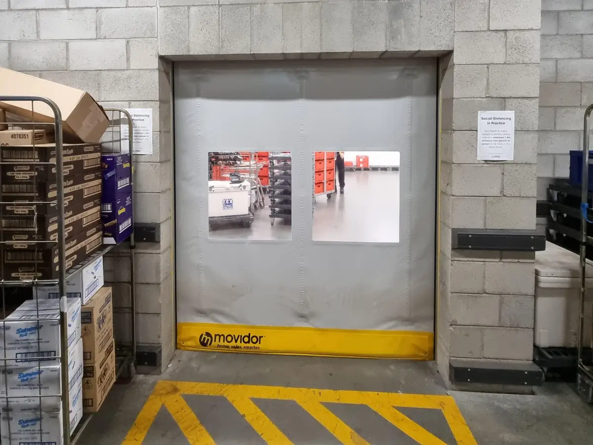 A grey EX series high speed door inside a supermarket loading dock area Coles Glenvale