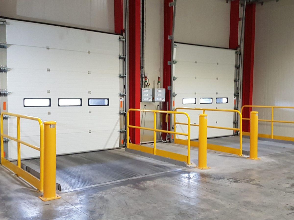 Two closed sectional doors in a warehouse.