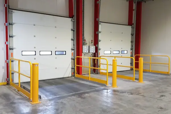 Two closed sectional doors in a warehouse.