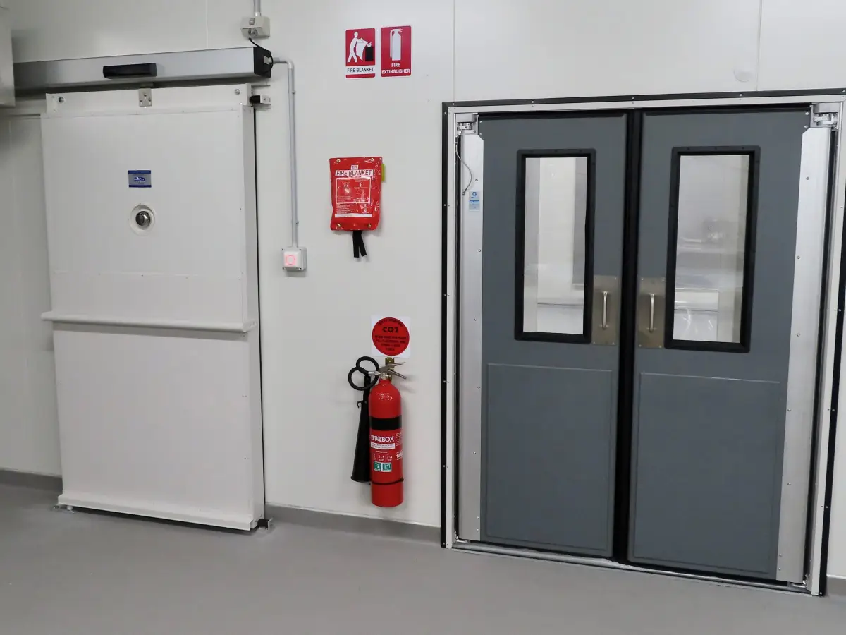 A traffic door and automated sliding door in a food processing factory of Tasty Fresh